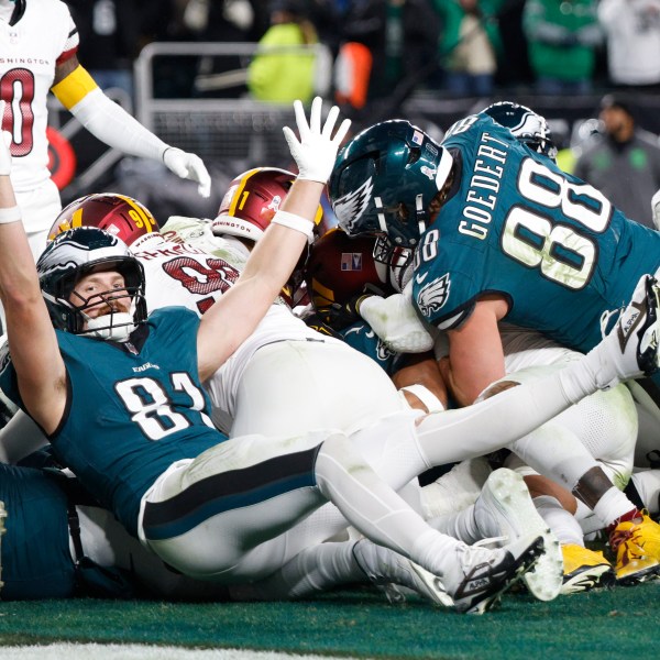 Philadelphia Eagles tight end Grant Calcaterra (81) celebrates a 1-yard touchdown by teammate Jalen Hurts during the second half of an NFL football game against the Washington Commanders Thursday, Nov. 14, 2024, in Philadelphia. (AP Photo/Laurence Kesterson)