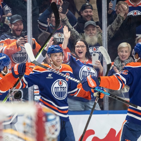 Edmonton Oilers' Connor McDavid (97) celebrates his 1000th point, against the Nashville Predators during the second period of an NHL hockey game, Thursday, Nov. 14, 2024 in Edmonton, Alberta. (Jason Franson/The Canadian Press via AP)