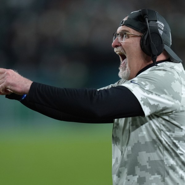 Washington Commanders head coach Dan Quinn celebrates a 1-yard touchdown run by Commanders running back Brian Robinson Jr. during the first half of an NFL football game against the Philadelphia Eagles Thursday, Nov. 14, 2024, in Philadelphia. (AP Photo/Chris Szagola)