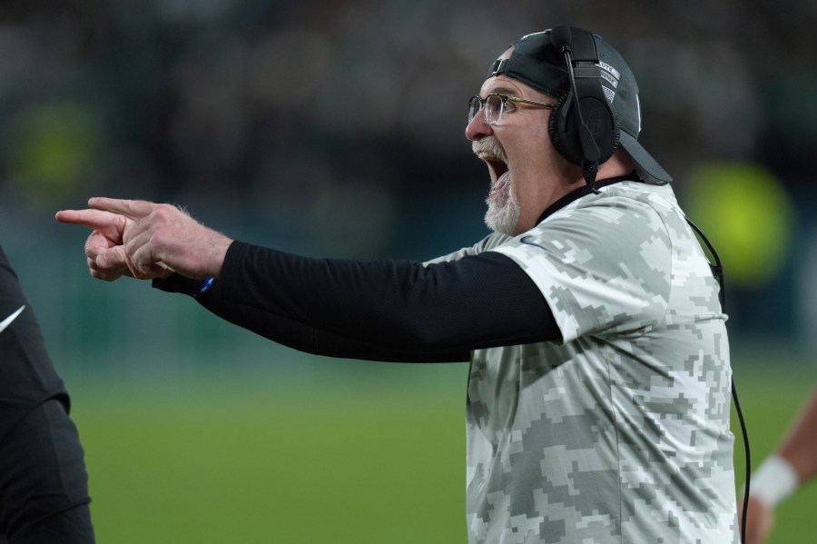 Washington Commanders head coach Dan Quinn celebrates a 1-yard touchdown run by Commanders running back Brian Robinson Jr. during the first half of an NFL football game against the Philadelphia Eagles Thursday, Nov. 14, 2024, in Philadelphia. (AP Photo/Chris Szagola)