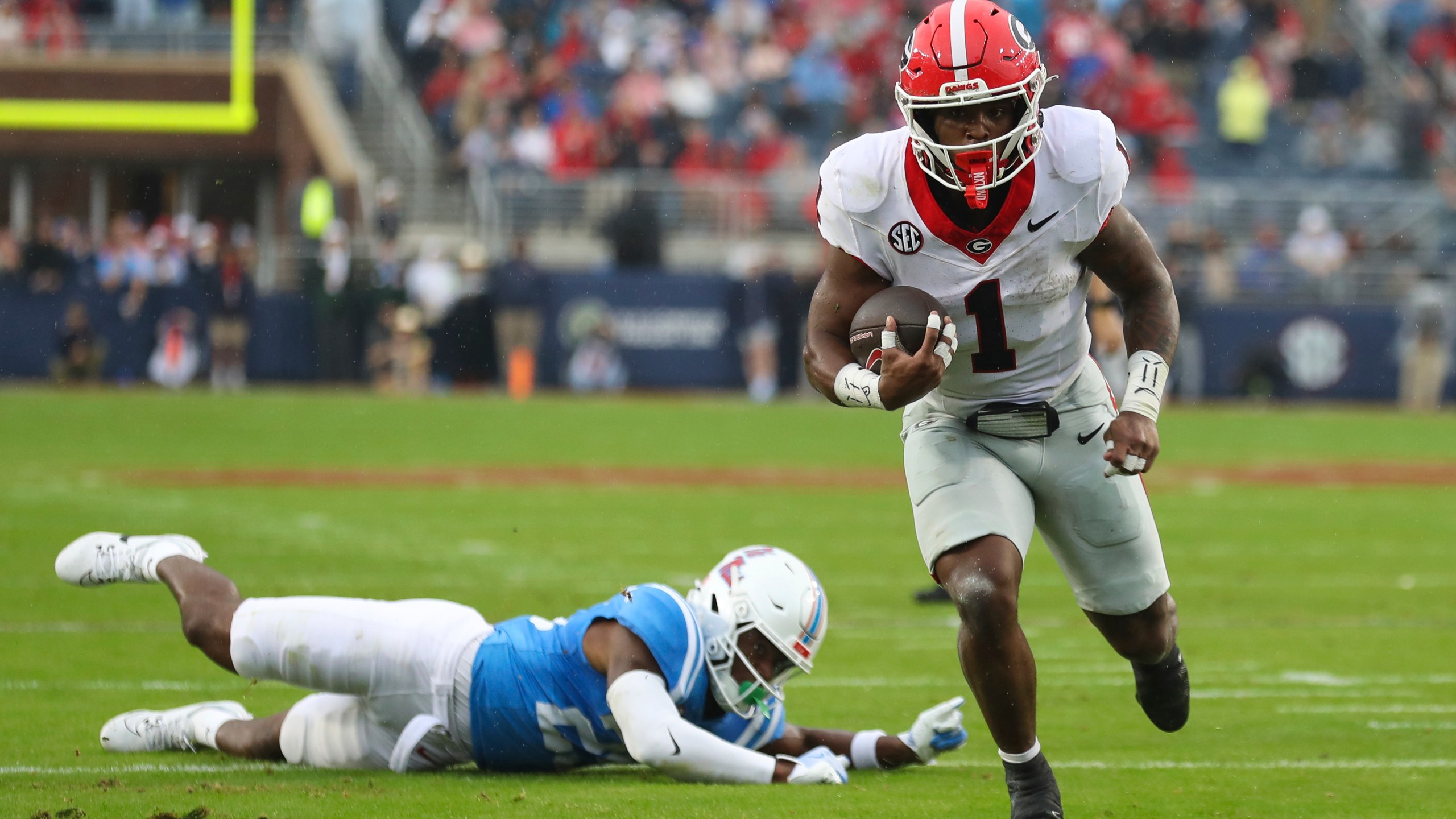 Georgia running back Trevor Etienne (1) runs the ball during the first half of an NCAA college football game against Mississippi on Saturday, Nov. 9, 2024, in Oxford, Miss. (AP Photo/Randy J. Williams)