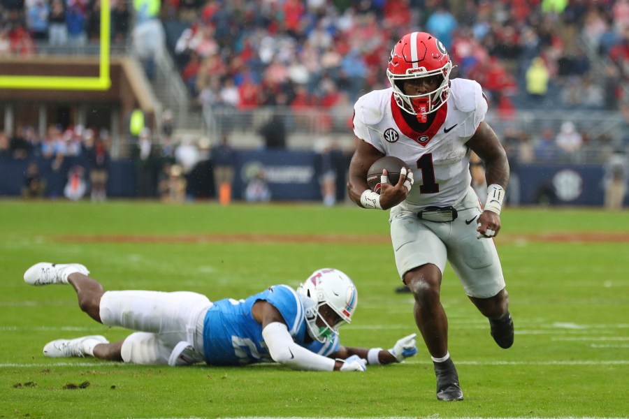 Georgia running back Trevor Etienne (1) runs the ball during the first half of an NCAA college football game against Mississippi on Saturday, Nov. 9, 2024, in Oxford, Miss. (AP Photo/Randy J. Williams)