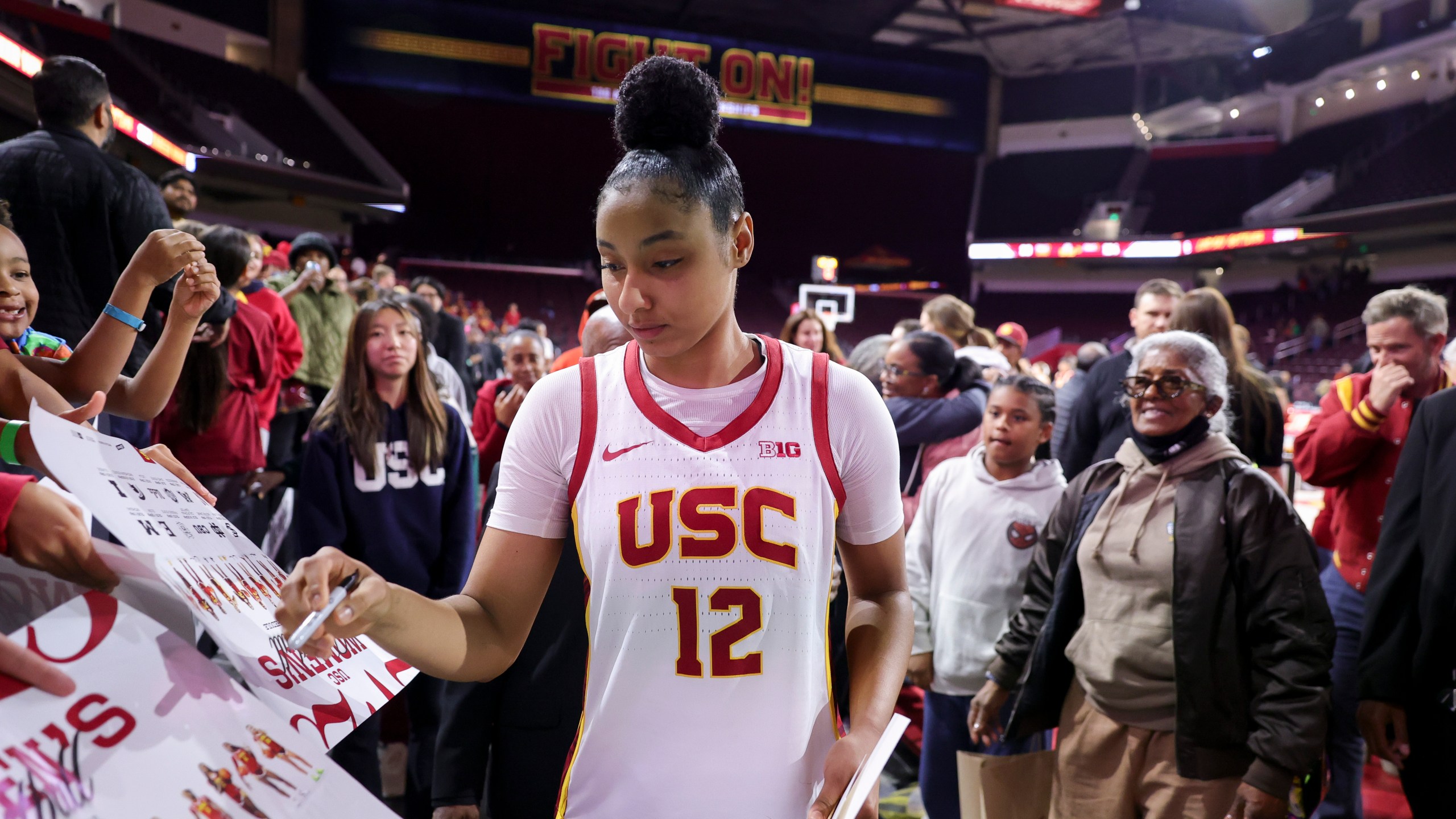 Southern California guard JuJu Watkins signs autographs after an NCAA women's basketball game against Cal State Northridge Tuesday, Nov. 12, 2024, in Los Angeles. (AP Photo/Ryan Sun)