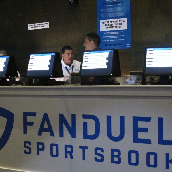 FILE - Workers at the FanDuel sports book at the Meadowlands Racetrack in East Rutherford, N.J., prepare to take bets, July 14, 2018. (AP Photo/Wayne Parry, File)