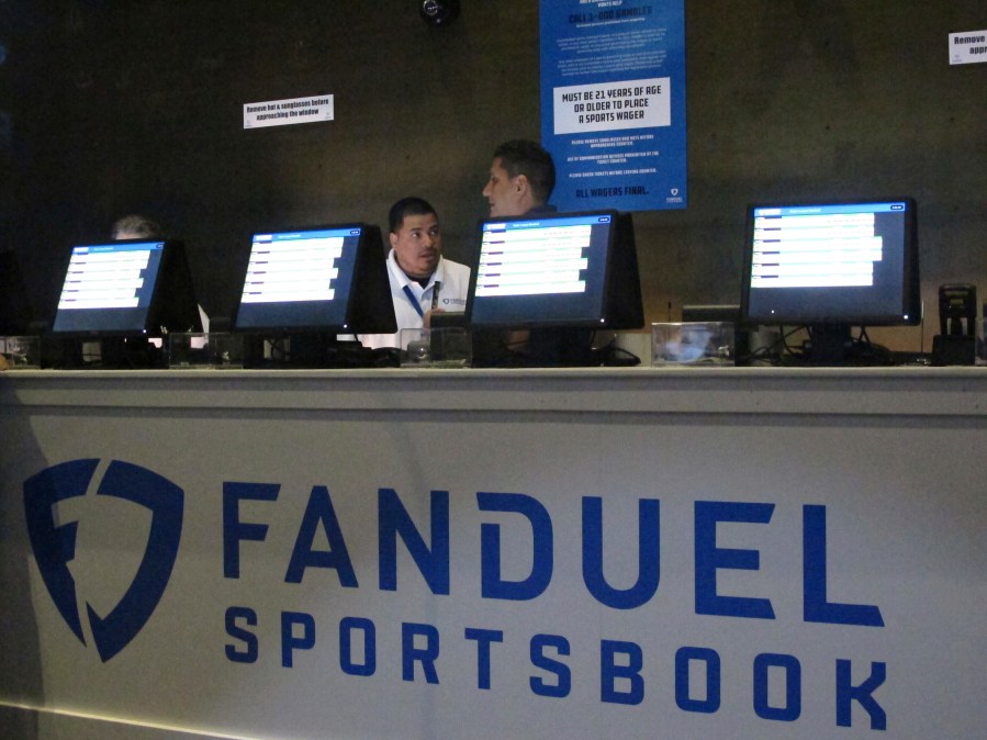 FILE - Workers at the FanDuel sports book at the Meadowlands Racetrack in East Rutherford, N.J., prepare to take bets, July 14, 2018. (AP Photo/Wayne Parry, File)