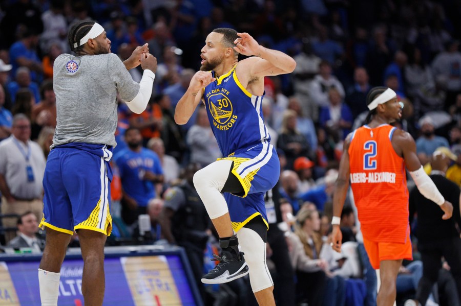 Golden State Warriors guard Buddy Hield, left, and Golden State Warriors guard Stephen Curry (30) celebrate as Oklahoma City Thunder guard Shai Gilgeous-Alexander (2) leaves the court during the second half of an NBA basketball game Sunday, Nov. 10, 2024, in Oklahoma City. (AP Photo/Nate Billings)