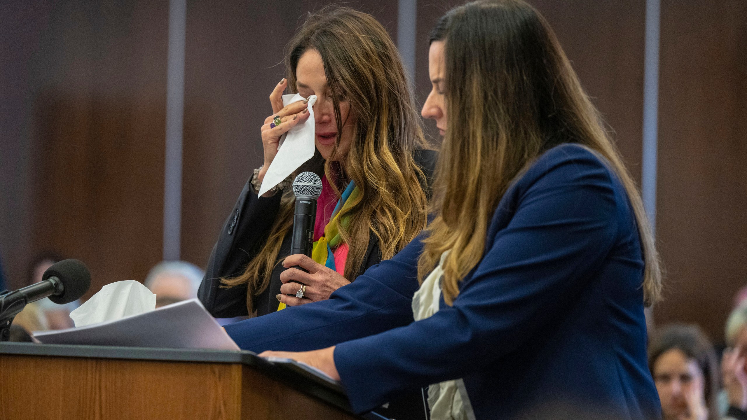 Jeanne Pepper, left, mother of Blaze Bernstein, wipes away tears as she gives a victim impact statement in court in Santa Ana, Calif., Friday, Nov. 15, 2024, prior to sentencing of Samuel Woodward, who was convicted of a hate crime murder for the killing of former classmate Blaze Bernstein. Senior Deputy District Attorney Jennifer Walker stands at right. (Mark Rightmire/The Orange County Register via AP, Pool)