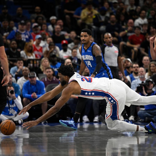 Philadelphia 76ers center Joel Embiid (21) dives after a loose ball against the Orlando Magic during the first half of an Emirates NBA Cup basketball game, Friday, Nov. 15, 2024, in Orlando, Fla. (AP Photo/Phelan M. Ebenhack)