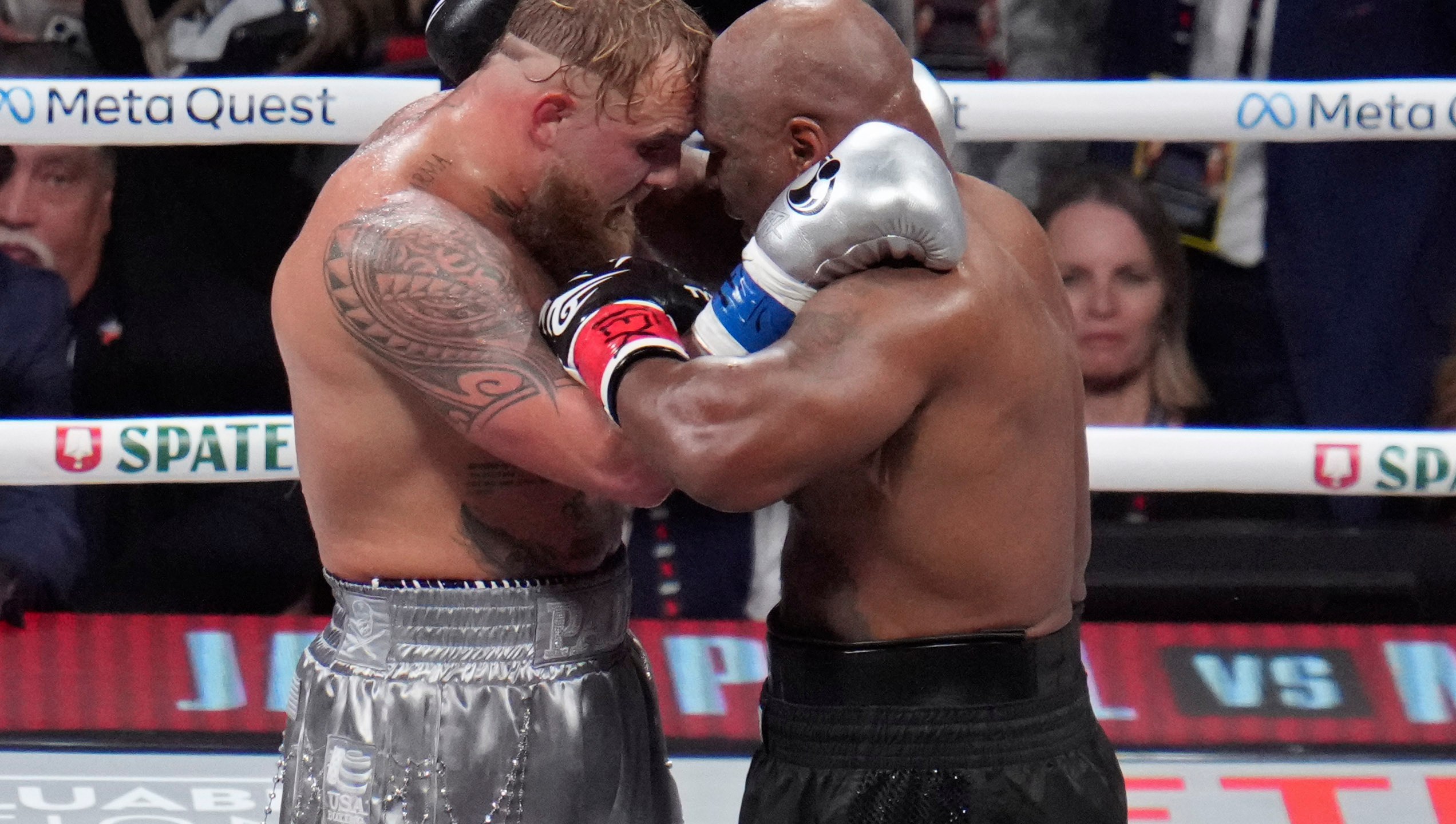 Jake Paul and Mike Tyson embrace after their heavyweight boxing match, Friday, Nov. 15, 2024, in Arlington, Texas. (AP Photo/Julio Cortez)