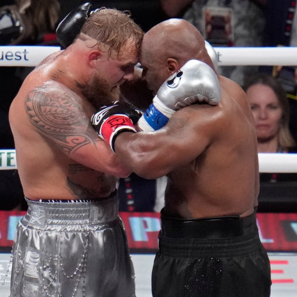 Jake Paul and Mike Tyson embrace after their heavyweight boxing match, Friday, Nov. 15, 2024, in Arlington, Texas. (AP Photo/Julio Cortez)