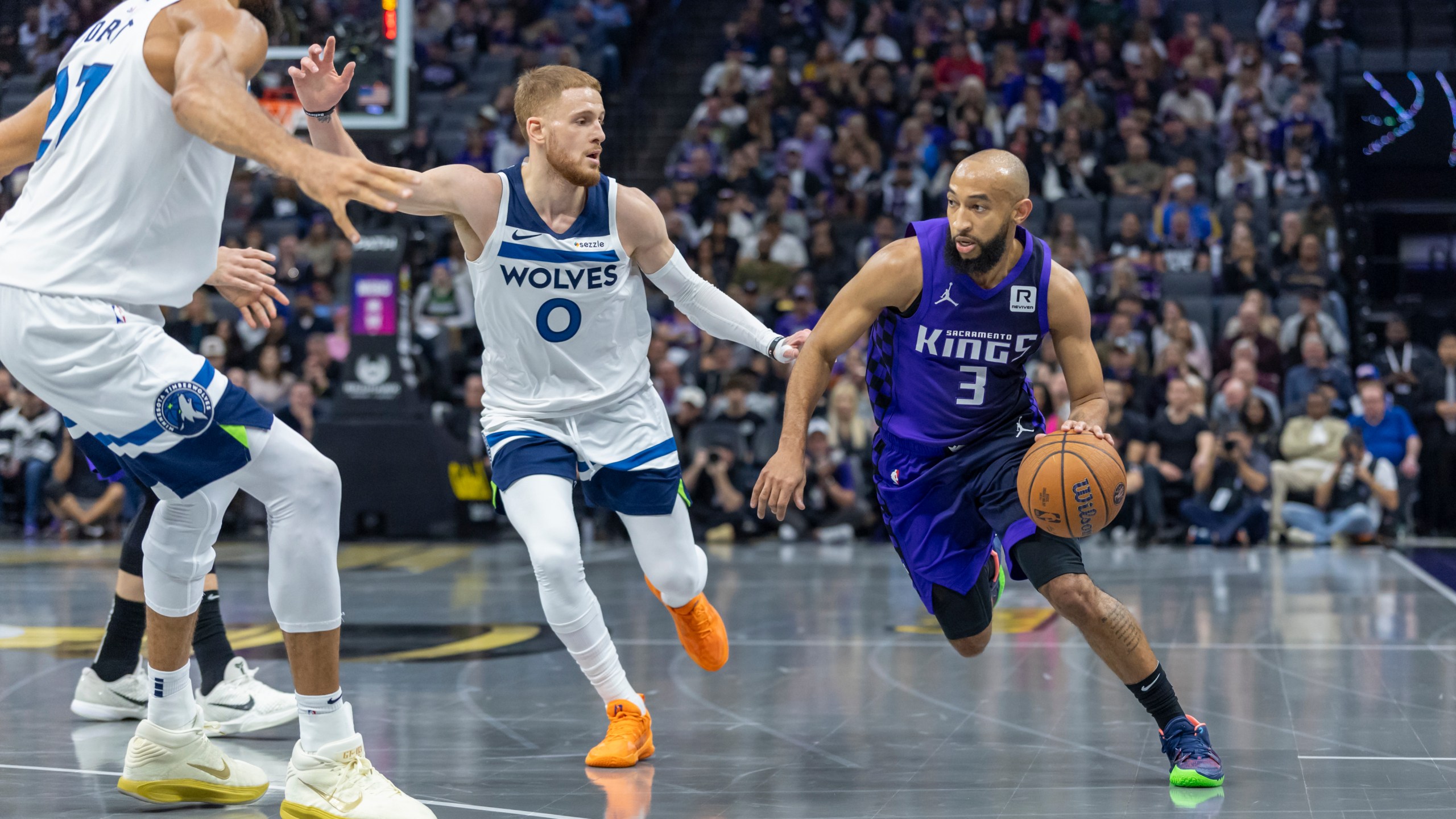 Sacramento Kings guard Jordan McLaughlin (3) drives to the basket with Minnesota Timberwolves guard Donte DiVincenzo (0) defending during the first half of an Emirates NBA Cup basketball game Friday, Nov. 15, 2024, in Sacramento, Calif. (AP Photo/Sara Nevis)