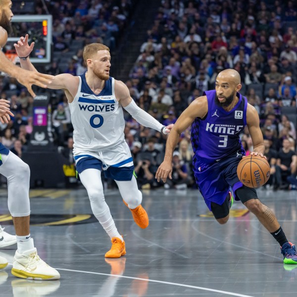 Sacramento Kings guard Jordan McLaughlin (3) drives to the basket with Minnesota Timberwolves guard Donte DiVincenzo (0) defending during the first half of an Emirates NBA Cup basketball game Friday, Nov. 15, 2024, in Sacramento, Calif. (AP Photo/Sara Nevis)