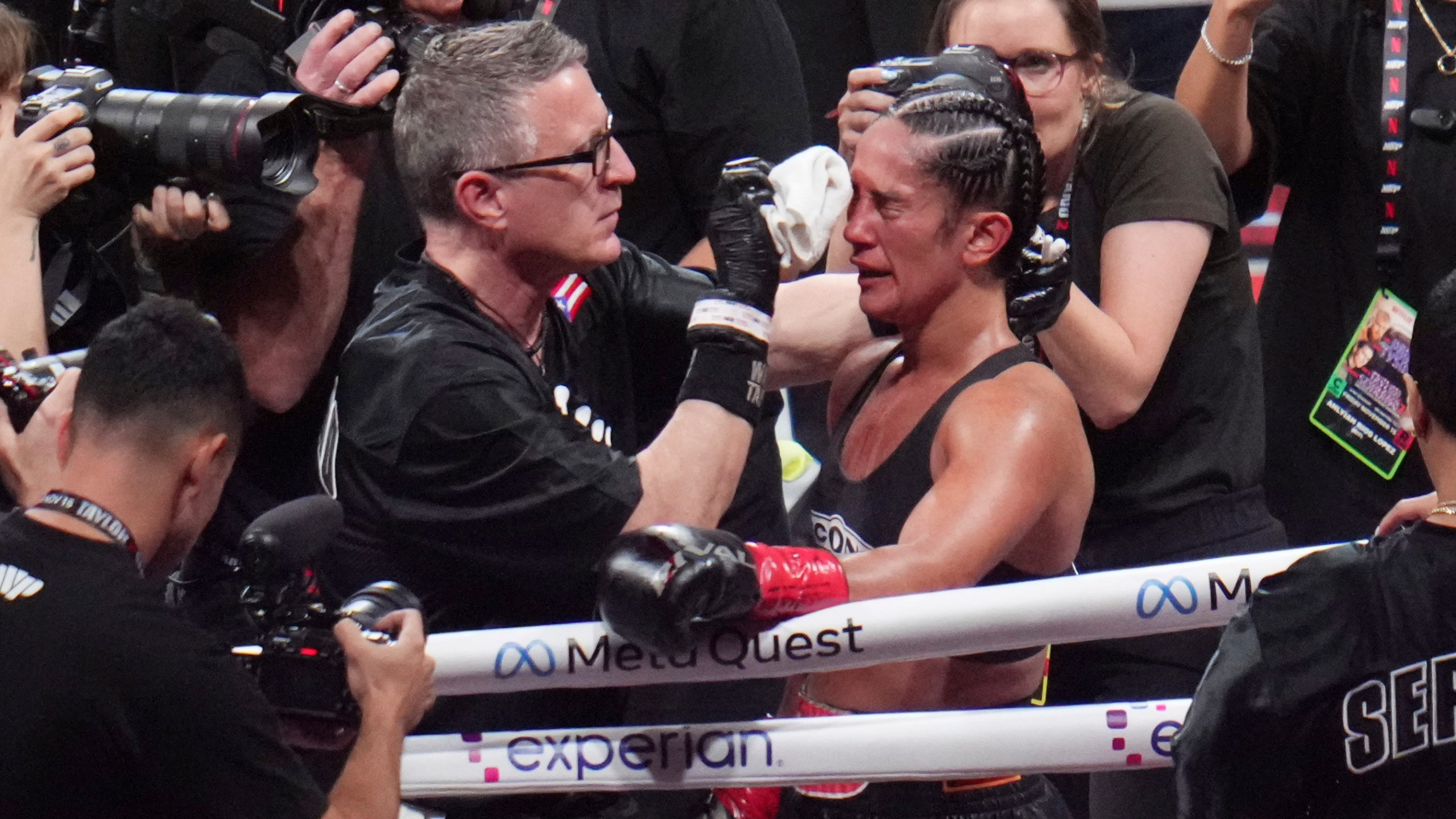 Amanda Serrano is attended to after fighting Katie Taylor in an undisputed super lightweight title bout, Friday, Nov. 15, 2024, in Arlington, Texas. (AP Photo/Julio Cortez)