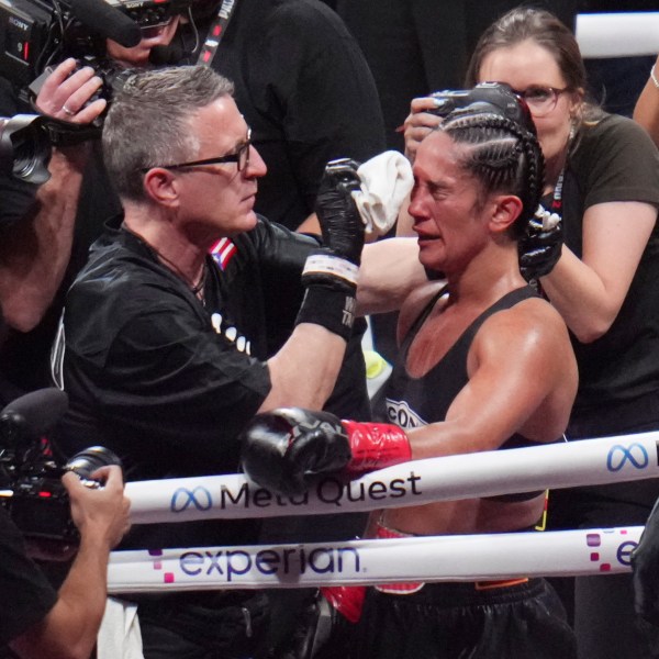 Amanda Serrano is attended to after fighting Katie Taylor in an undisputed super lightweight title bout, Friday, Nov. 15, 2024, in Arlington, Texas. (AP Photo/Julio Cortez)