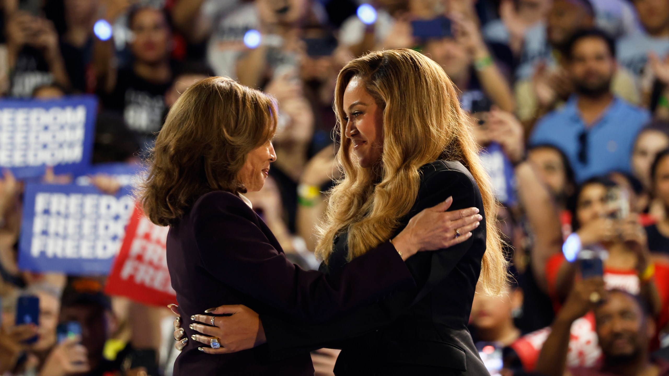 Musical artist Beyonce, right, and Democratic presidential nominee Vice President Kamala Harris, left, embrace on stage during a campaign rally Friday, Oct. 25, 2024, in Houston. (AP Photo/Annie Mulligan)