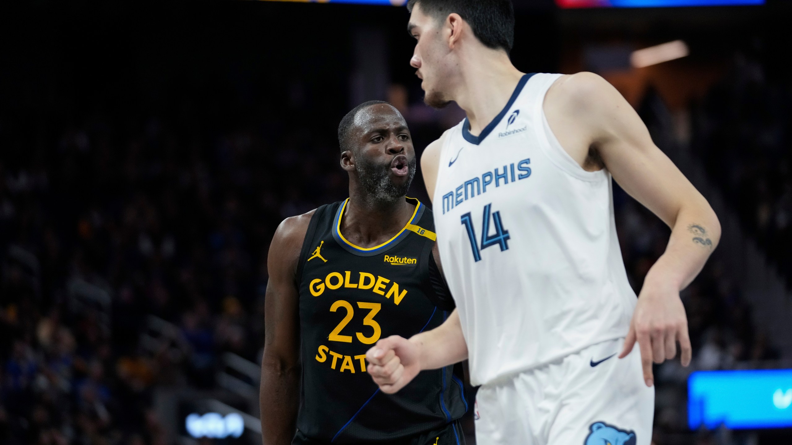 Golden State Warriors forward Draymond Green, left, reacts after making a 3-point basket during the second half of an Emirates NBA Cup basketball game against the Memphis Grizzlies, Friday, Nov. 15, 2024, in San Francisco. (AP Photo/Godofredo A. Vásquez)