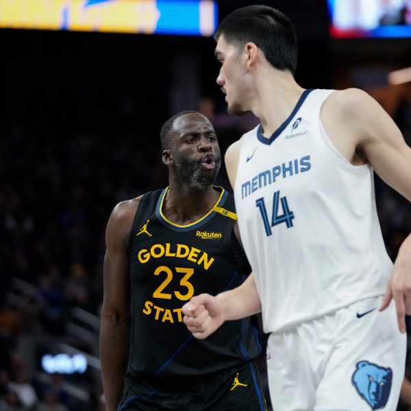 Golden State Warriors forward Draymond Green, left, reacts after making a 3-point basket during the second half of an Emirates NBA Cup basketball game against the Memphis Grizzlies, Friday, Nov. 15, 2024, in San Francisco. (AP Photo/Godofredo A. Vásquez)