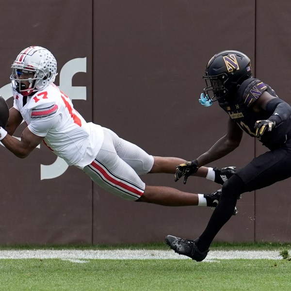 Ohio State wide receiver Carnell Tate State makes a diving touchdown reception as Northwestern defensive back Josh Fussell defends during the first half of an NCAA college football game at Wrigley Field, Saturday, Nov. 16, 2024, in Chicago. (AP Photo/Charles Rex Arbogast)