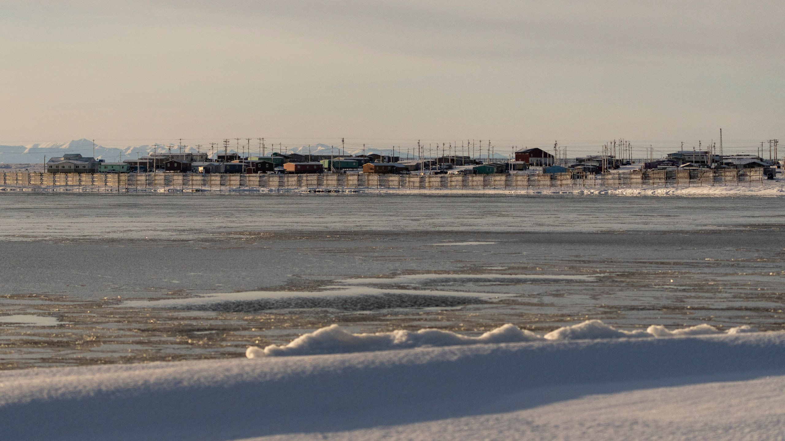 The village of Kaktovik is seen from across the waters of Pipsuk Bight, Tuesday, Oct. 15, 2024, in Kaktovik, Alaska. (AP Photo/Lindsey Wasson)