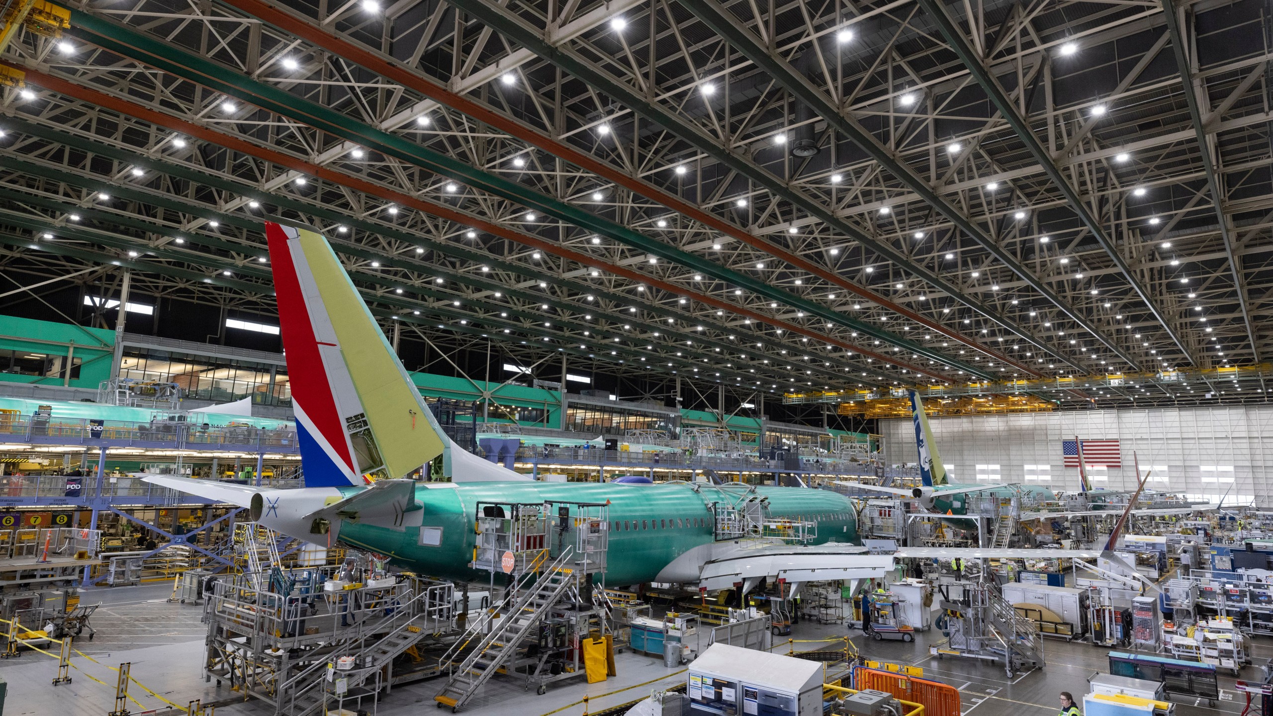 FILE - Boeing employees work on the 737 MAX on the final assembly line at Boeing's Renton plant, June 15, 2022, in Renton, Wash. (Ellen M. Banner/The Seattle Times via AP, Pool, File)