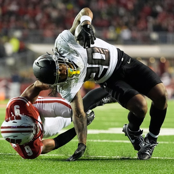 Wisconsin's Austin Brown (9) stops Oregon's Jordan James (20) during the second half of an NCAA college football game Saturday, Nov. 16, 2024, in Madison, Wis. Oregon won 16-13. (AP Photo/Morry Gash)