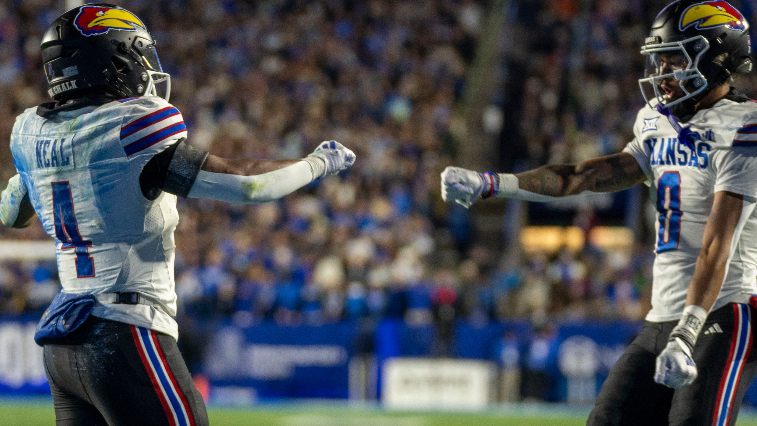 Kansas running back Devin Neal (4) celebrates his touchdown with Kansas wide receiver Quentin Skinner (0) during then first half of an NCAA college football game against BYU, Saturday, Nov. 16, 2024, in Provo. (AP Photo/Rick Egan)