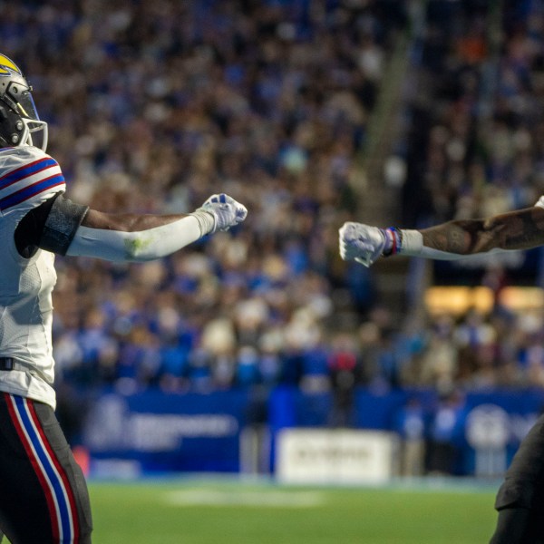 Kansas running back Devin Neal (4) celebrates his touchdown with Kansas wide receiver Quentin Skinner (0) during then first half of an NCAA college football game against BYU, Saturday, Nov. 16, 2024, in Provo. (AP Photo/Rick Egan)