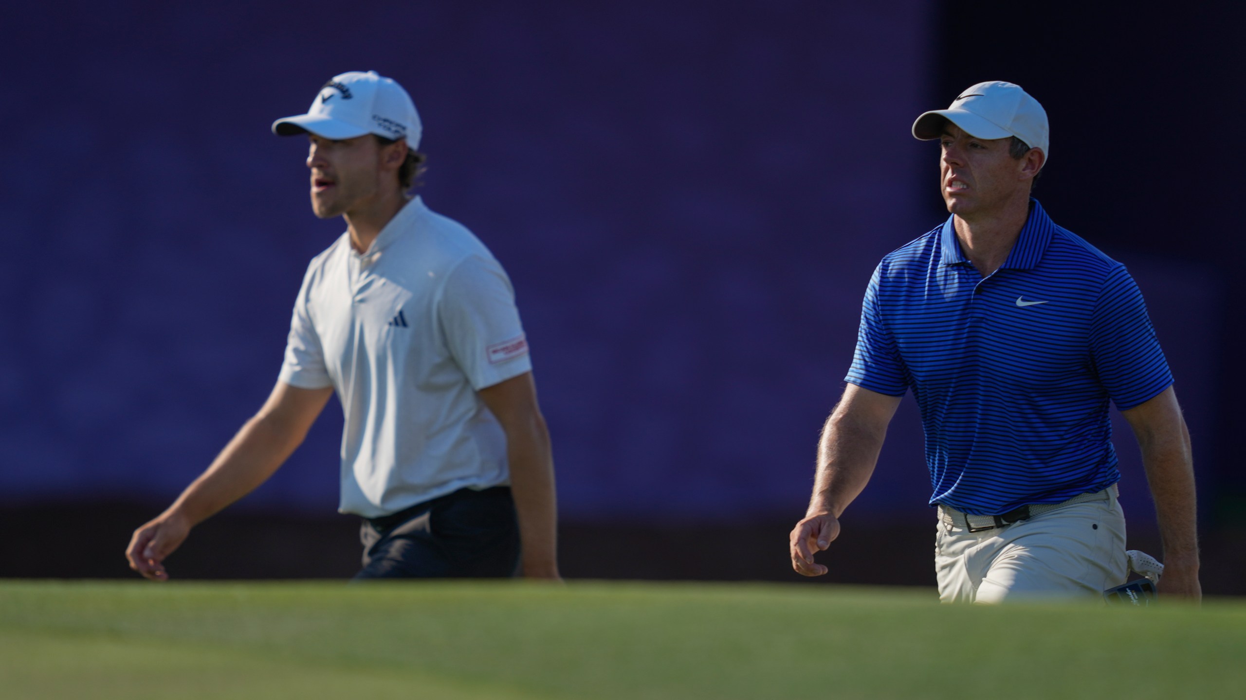 Rasmus Højgaard of Denmark, left, and Rory McIlroy of Northern Ireland walk towards 17th green in the final round of World Tour Golf Championship in Dubai, United Arab Emirates, Sunday, Nov. 17, 2024. (AP Photo/Altaf Qadri)