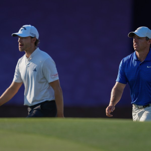 Rasmus Højgaard of Denmark, left, and Rory McIlroy of Northern Ireland walk towards 17th green in the final round of World Tour Golf Championship in Dubai, United Arab Emirates, Sunday, Nov. 17, 2024. (AP Photo/Altaf Qadri)