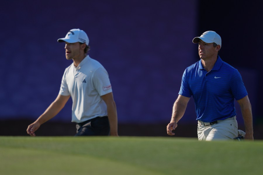 Rasmus Højgaard of Denmark, left, and Rory McIlroy of Northern Ireland walk towards 17th green in the final round of World Tour Golf Championship in Dubai, United Arab Emirates, Sunday, Nov. 17, 2024. (AP Photo/Altaf Qadri)