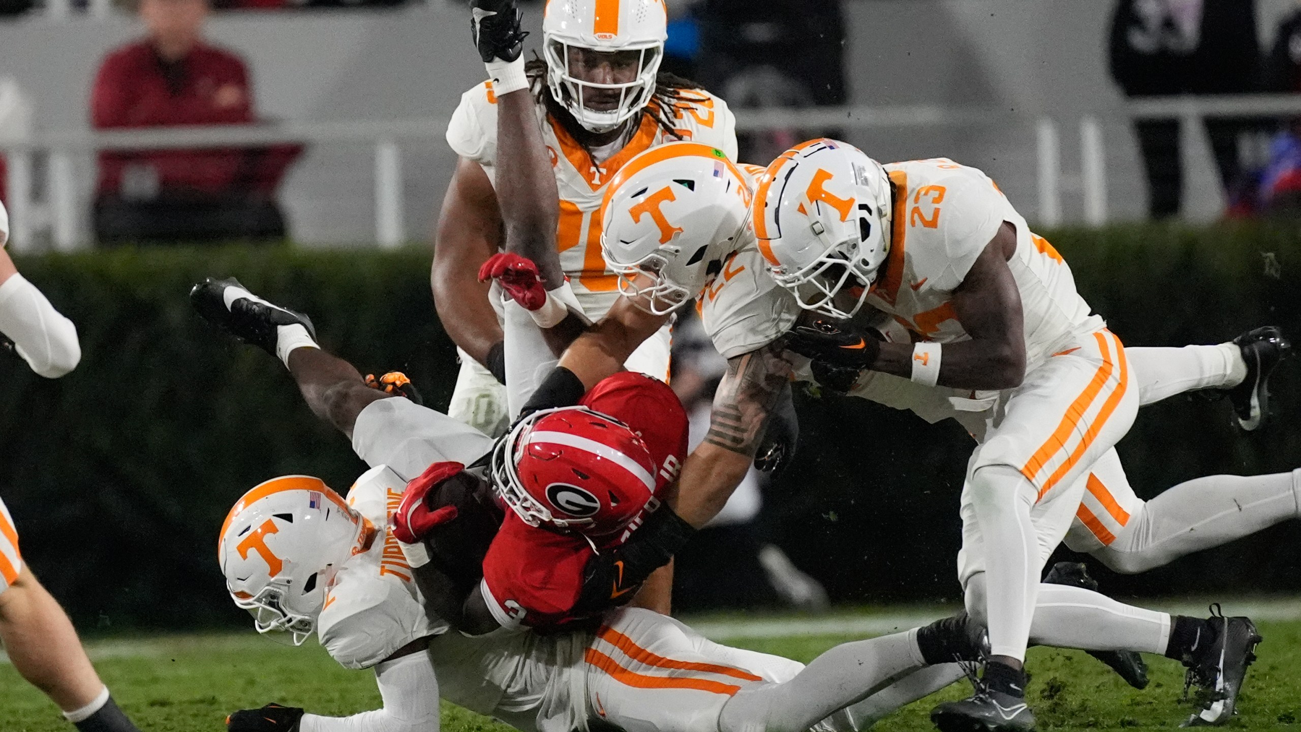 Georgia running back Nate Frazier (3) is stopped by Tennessee defensive back Andre Turrentine (2), defensive back Boo Carter (23) and linebacker Jeremiah Telander (22) during the first half of an NCAA college football game, Saturday, Nov. 16, 2024, in Athens, Ga. (AP Photo/John Bazemore)