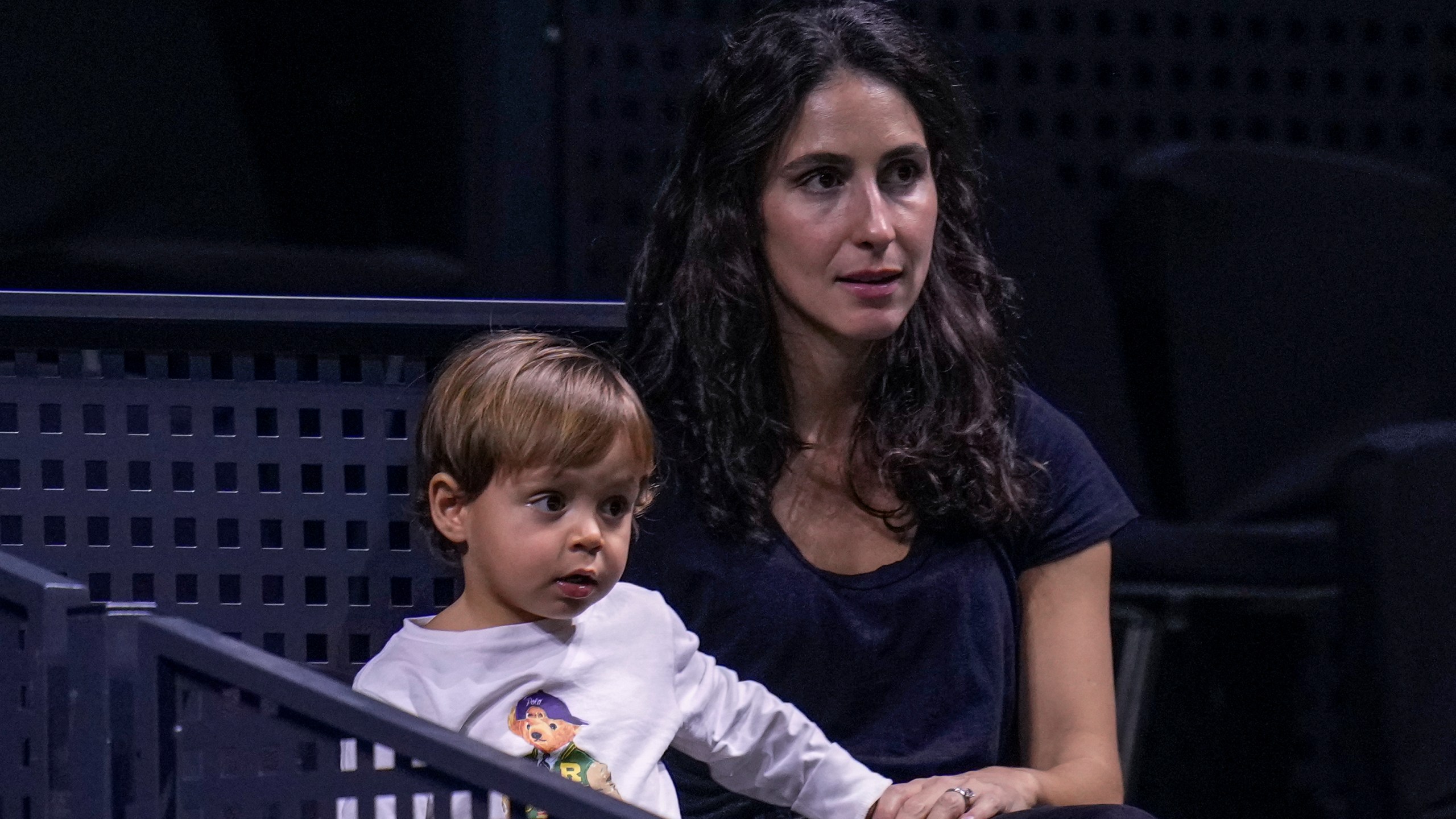 Rafael Nadal's wife, Xisca Perello, and their son, Rafael Nadal Jr watch the training session of Rafael Nadal at the Martin Carpena Sports Hall, in Malaga, southern Spain, on Saturday, Nov. 16, 2024. (AP Photo/Manu Fernandez)