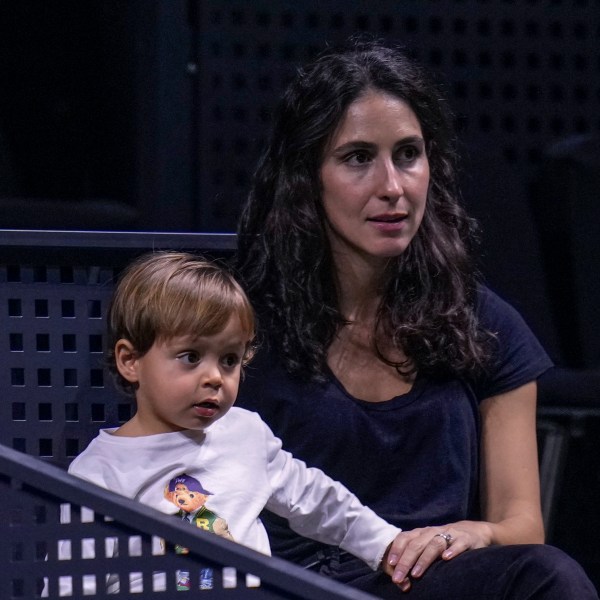 Rafael Nadal's wife, Xisca Perello, and their son, Rafael Nadal Jr watch the training session of Rafael Nadal at the Martin Carpena Sports Hall, in Malaga, southern Spain, on Saturday, Nov. 16, 2024. (AP Photo/Manu Fernandez)