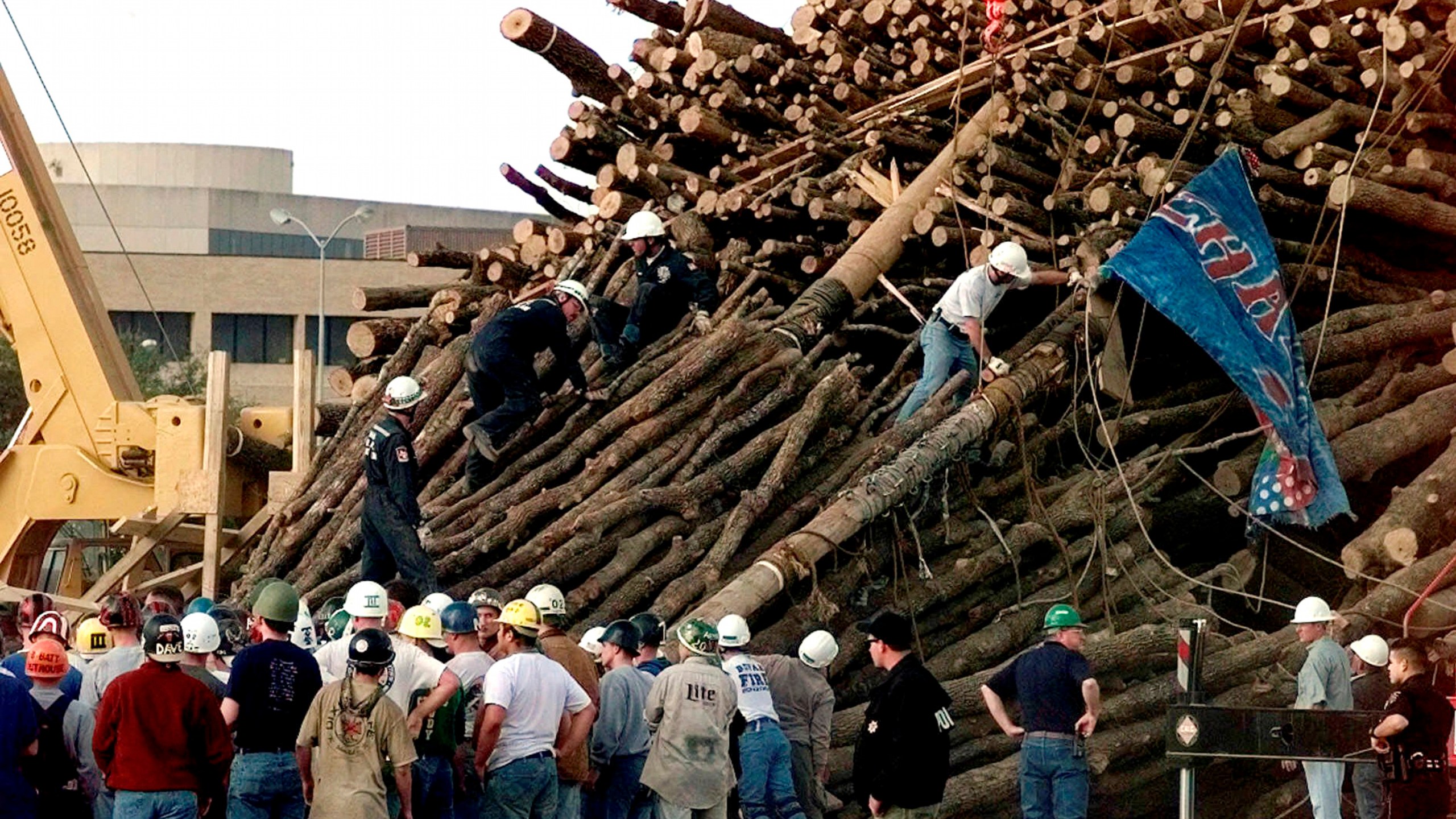 FILE - Texas A&M students and rescue workers gathered at the base of the collapsed bonfire stack as the search continues for victims in College Station, Texas, Nov. 18, 1999. (AP Photo/Pat Sullivan, File)