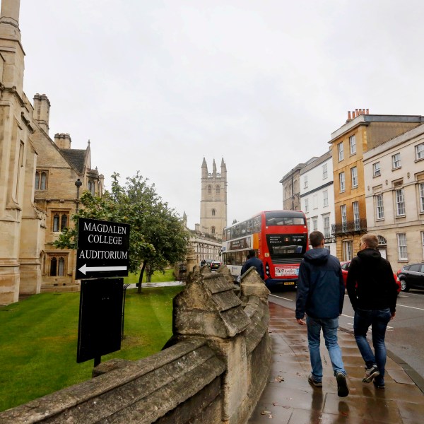 FILE - People walk around Oxford University's campus on Sept. 3, 2017, in Oxford, England. (AP Photo/Caroline Spiezio, File)