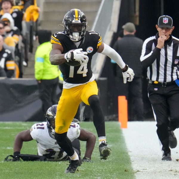 Pittsburgh Steelers wide receiver George Pickens (14) avoids a tackle by Baltimore Ravens cornerback Brandon Stephens (21) during the second half of an NFL football game, Sunday, Nov. 17, 2024, in Pittsburgh. (AP Photo/Gene J. Puskar)