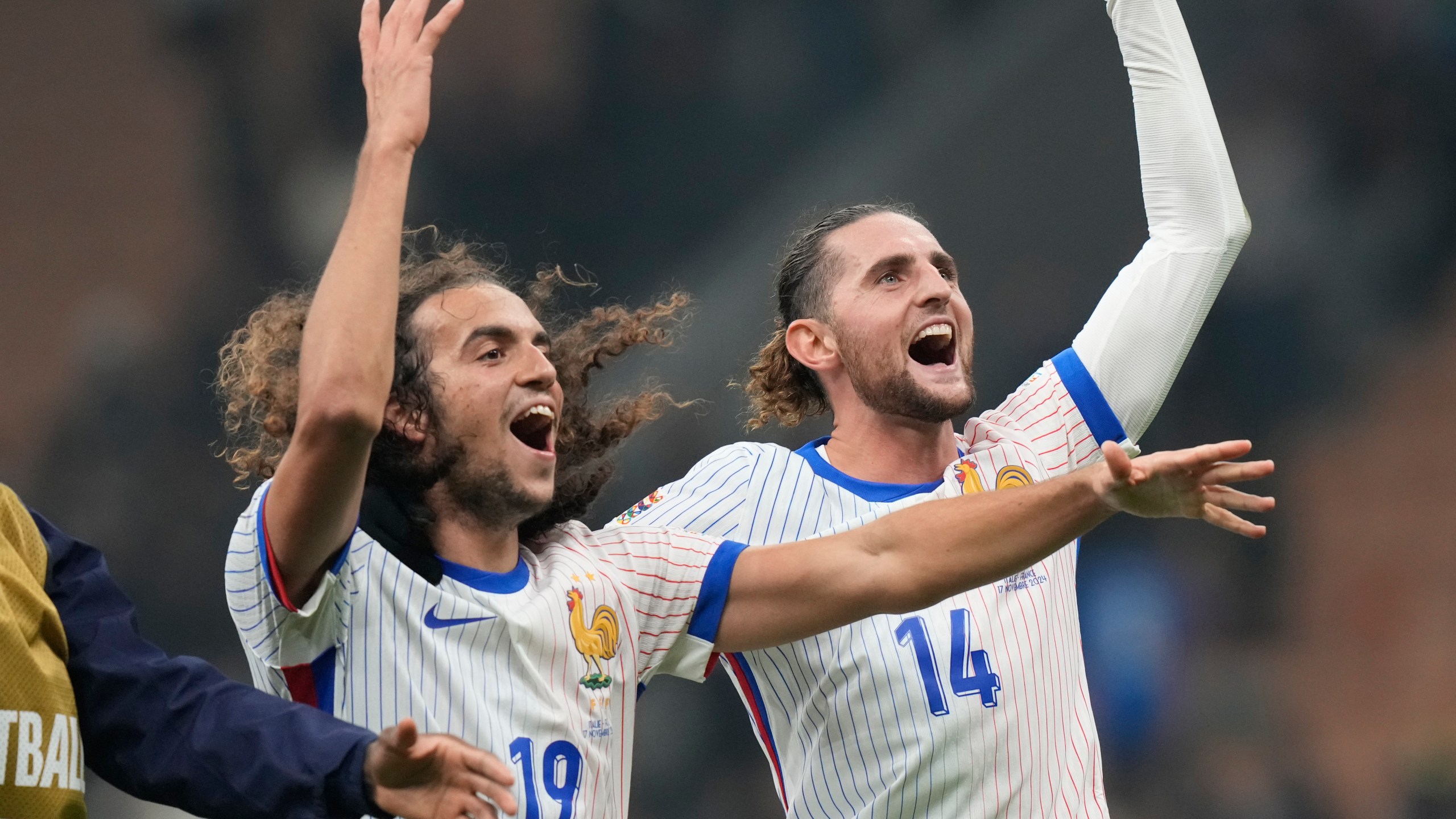 France's Adrien Rabiot, right, celebrates with Matteo Guendouzi after the Nations League soccer match between Italy and France, at the San Siro stadium in Milan, Italy, Sunday, Nov. 17, 2024. (AP Photo/Luca Bruno)