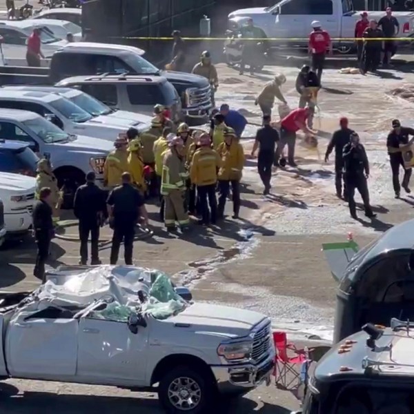 This image taken from video provided by Jerry Jordan shows the fire department and others working at the site of a single-engine plane crash Sunday, Nov. 17, 2024, near a Southern California racing event, in Pomona, Calif., about 30 miles (50 kilometers) east of downtown Los Angeles. (Jerry Jordan via AP)