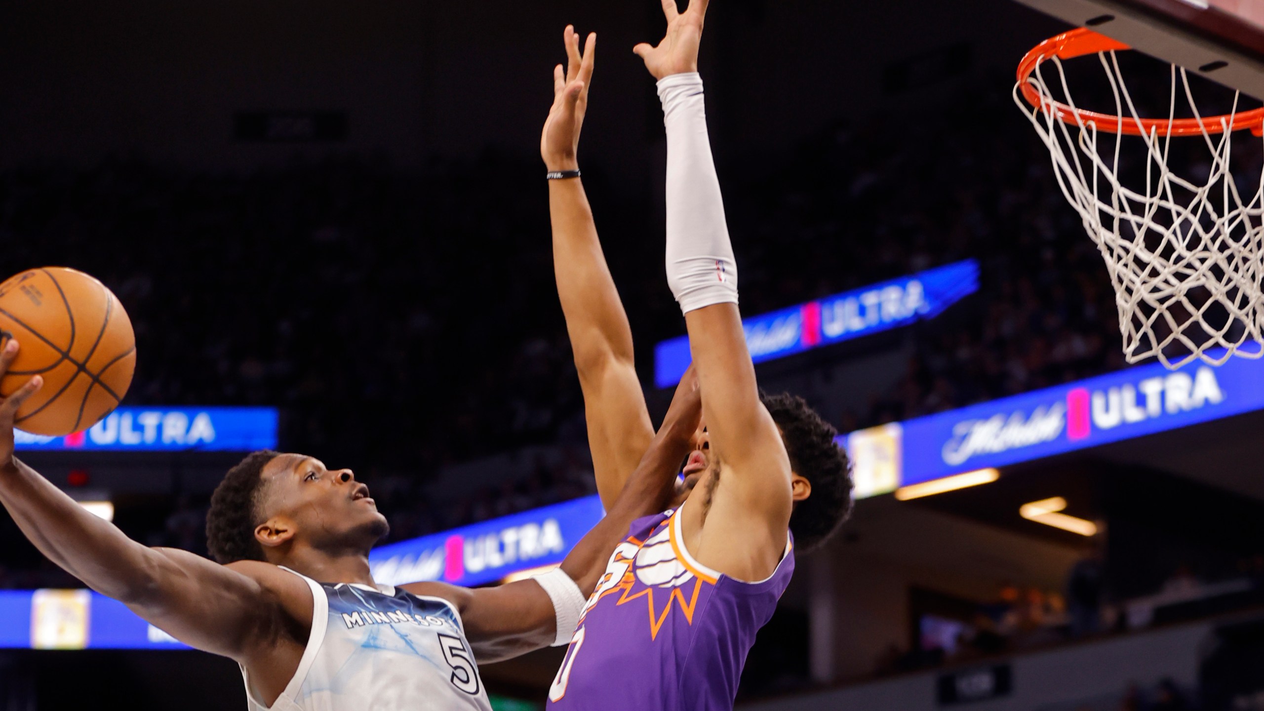 Minnesota Timberwolves guard Anthony Edwards (5) goes to the basket against Phoenix Suns forward Royce O'Neale (0) in the first quarter of an NBA basketball game Sunday, Nov. 17, 2024, in Minneapolis. (AP Photo/Bruce Kluckhohn)