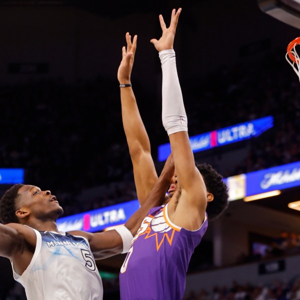 Minnesota Timberwolves guard Anthony Edwards (5) goes to the basket against Phoenix Suns forward Royce O'Neale (0) in the first quarter of an NBA basketball game Sunday, Nov. 17, 2024, in Minneapolis. (AP Photo/Bruce Kluckhohn)