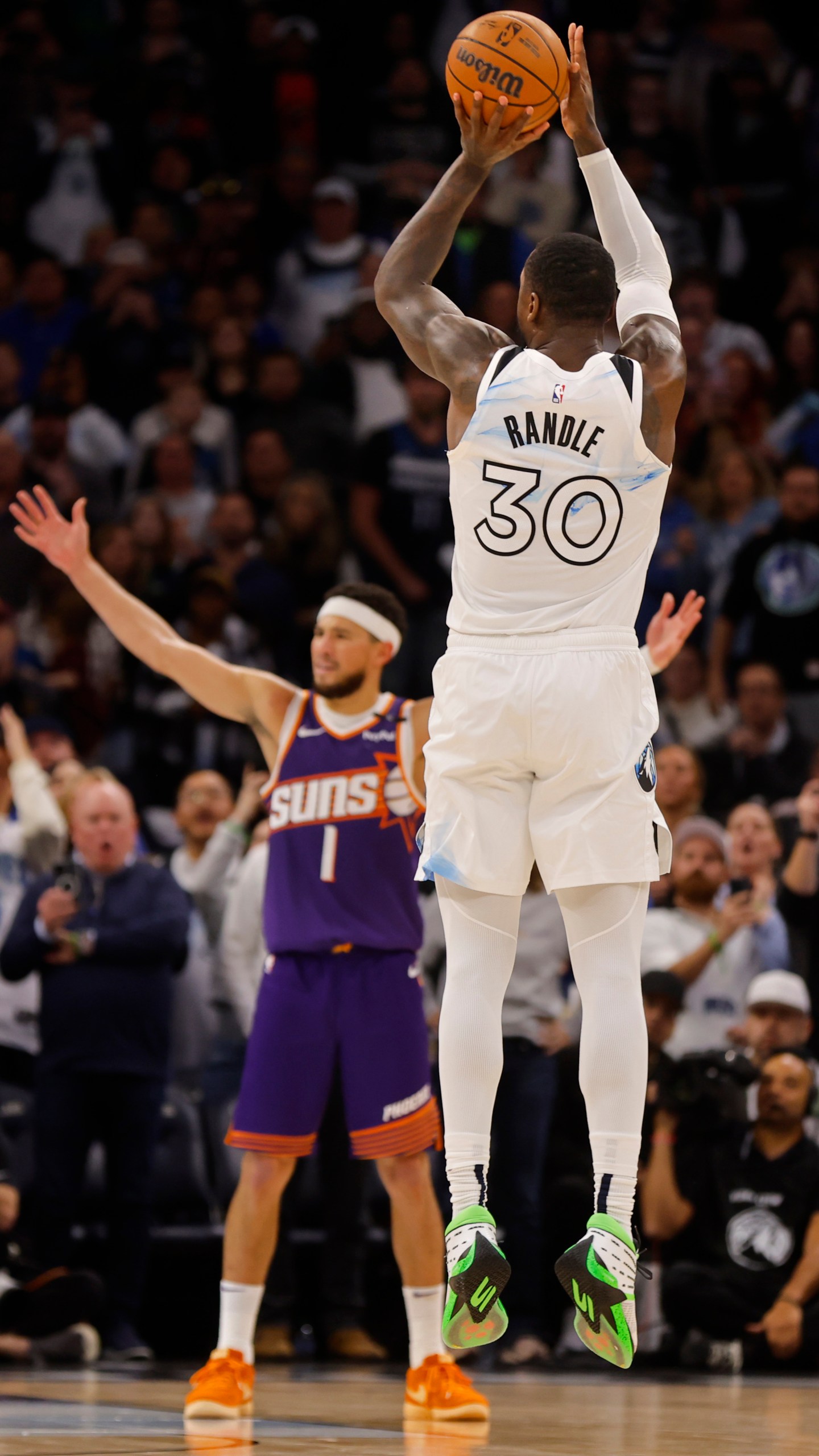 Minnesota Timberwolves forward Julius Randle (30) goes up to shoot a 3-point basket to defeat the Phoenix Suns as time ends in the fourth quarter of an NBA basketball game Sunday, Nov. 17, 2024, in Minneapolis. (AP Photo/Bruce Kluckhohn)