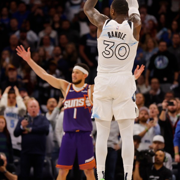 Minnesota Timberwolves forward Julius Randle (30) goes up to shoot a 3-point basket to defeat the Phoenix Suns as time ends in the fourth quarter of an NBA basketball game Sunday, Nov. 17, 2024, in Minneapolis. (AP Photo/Bruce Kluckhohn)