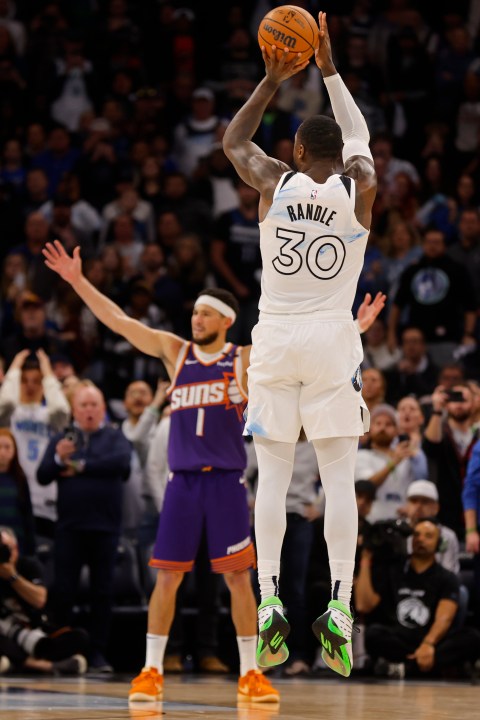 Minnesota Timberwolves forward Julius Randle (30) goes up to shoot a 3-point basket to defeat the Phoenix Suns as time ends in the fourth quarter of an NBA basketball game Sunday, Nov. 17, 2024, in Minneapolis. (AP Photo/Bruce Kluckhohn)