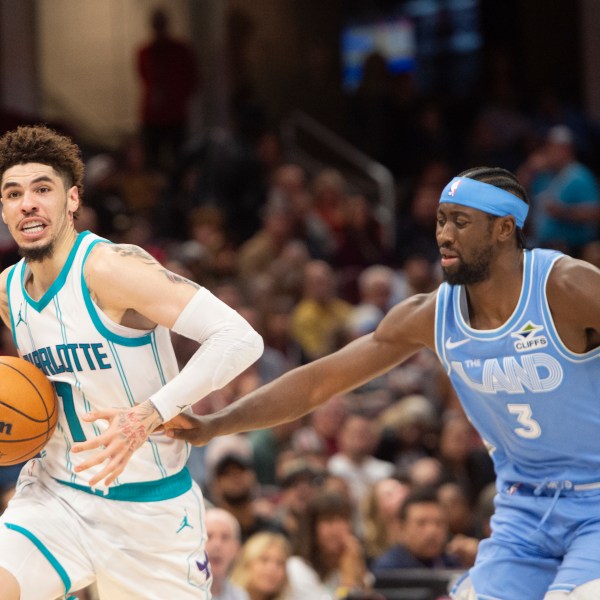 Charlotte Hornets' LaMelo Ball (1) drives past Cleveland Cavaliers' Caris LeVert (3) during the second half of an NBA basketball game in Cleveland, Sunday, Nov 17, 2024. (AP Photo/Phil Long)