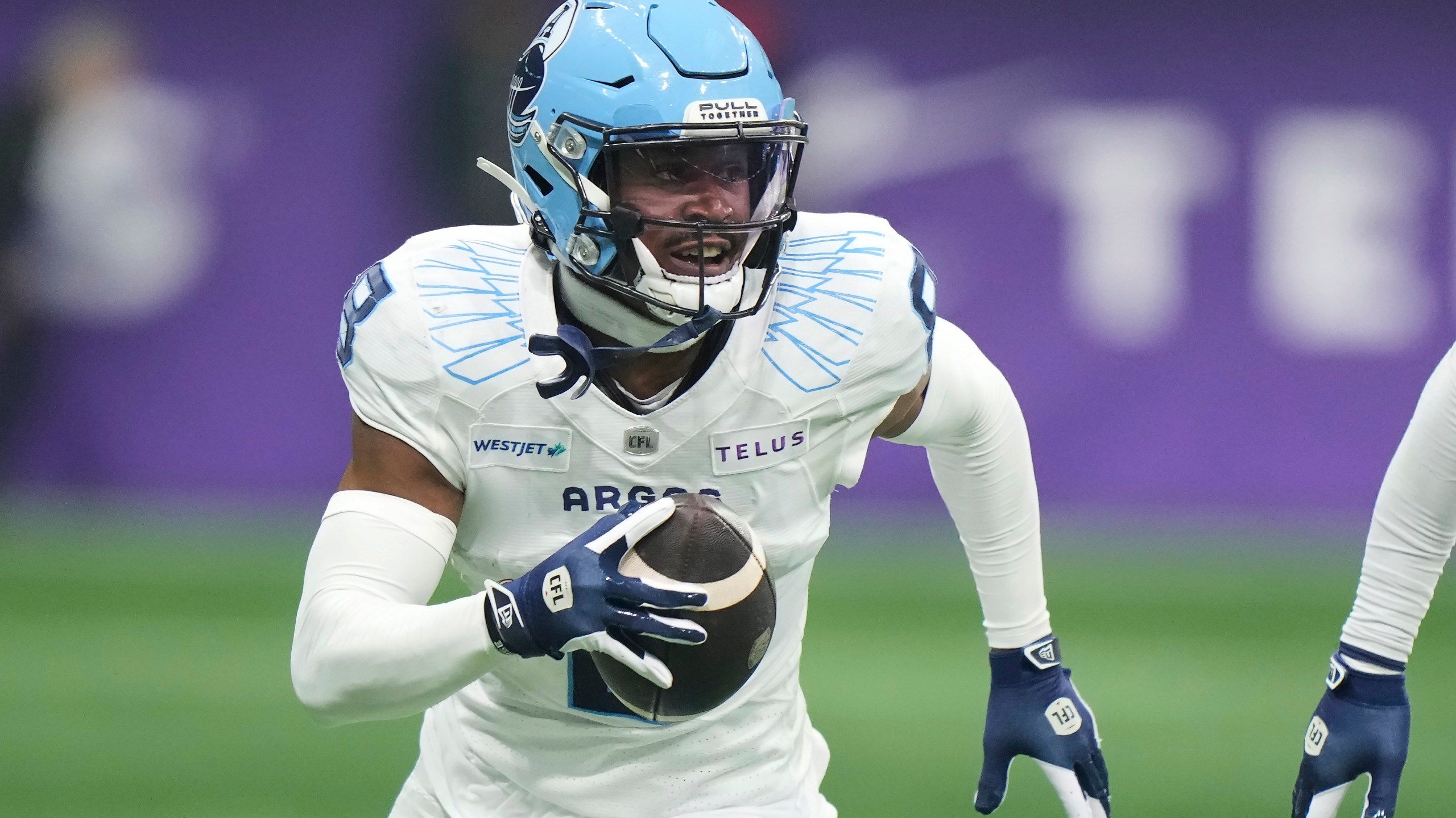 Toronto Argonauts' DaShaun Amos (8) runs back an interception against the Winnipeg Blue Bombers during the second half of a CFL football game at the 111th Grey Cup in Vancouver, British Columbia, Sunday, Nov. 17, 2024. (Frank Gunn/The Canadian Press via AP)