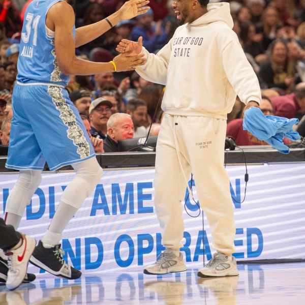 Cleveland Cavaliers' Jarrett Allen (31) is greeted by Donovan Mitchell, right, during the first half of an NBA basketball game against the Charlotte Hornets in Cleveland, Sunday, Nov 17, 2024. Mitchell did not play in the game. (AP Photo/Phil Long)