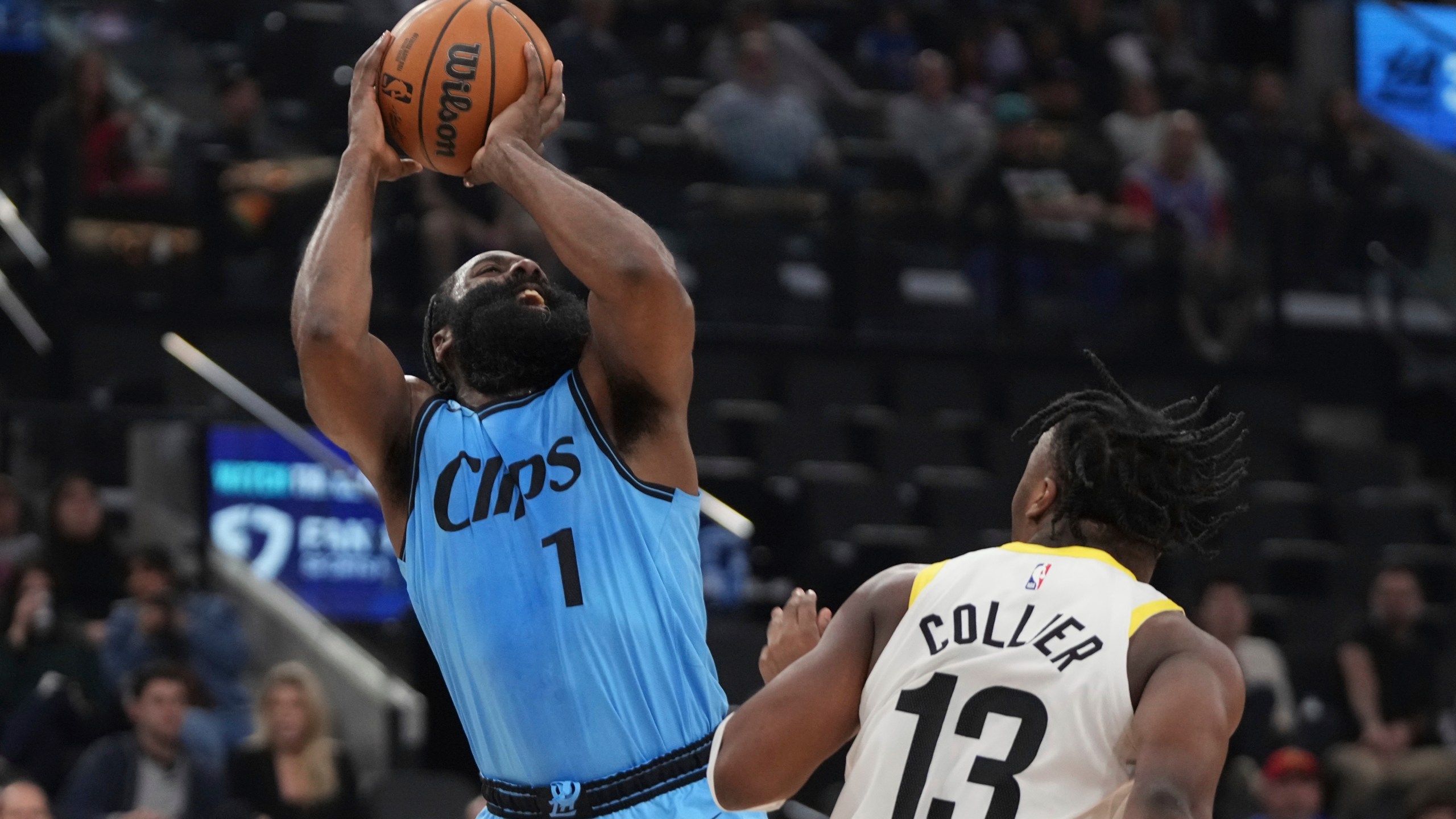 Los Angeles Clippers guard James Harden, left, shoots as Utah Jazz guard Isaiah Collier defends during the first half of an NBA basketball game, Sunday, Nov. 17, 2024, in Inglewood, Calif. (AP Photo/Mark J. Terrill)