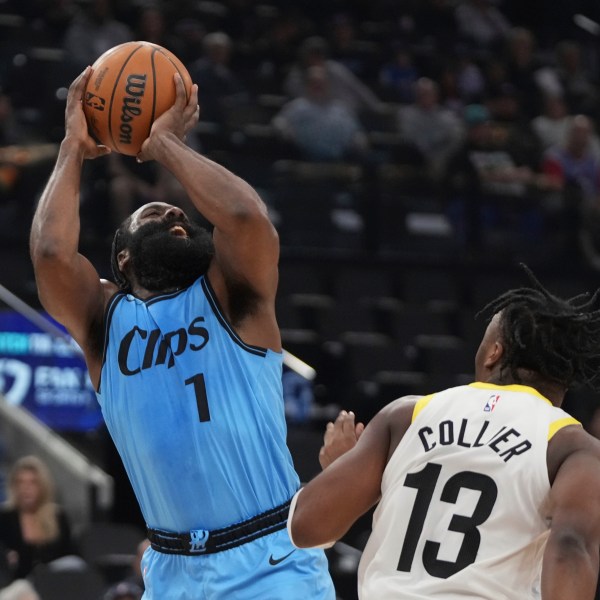 Los Angeles Clippers guard James Harden, left, shoots as Utah Jazz guard Isaiah Collier defends during the first half of an NBA basketball game, Sunday, Nov. 17, 2024, in Inglewood, Calif. (AP Photo/Mark J. Terrill)