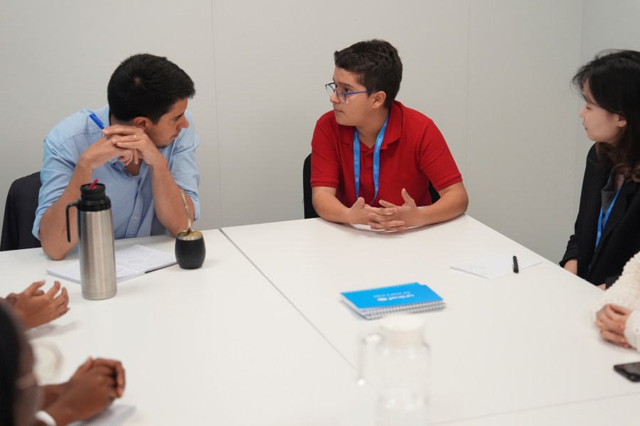 Francisco Vera Manzanares, 15, center, a climate activist from Colombia, speaks with Felipe Paullier, left, U.N. assistant secretary-general for youth affairs, during a forum with young activists, Tuesday, Nov. 12, 2024, at the COP29 U.N. Climate Summit in Baku, Azerbaijan. (AP Photo/Joshua A. Bickel)