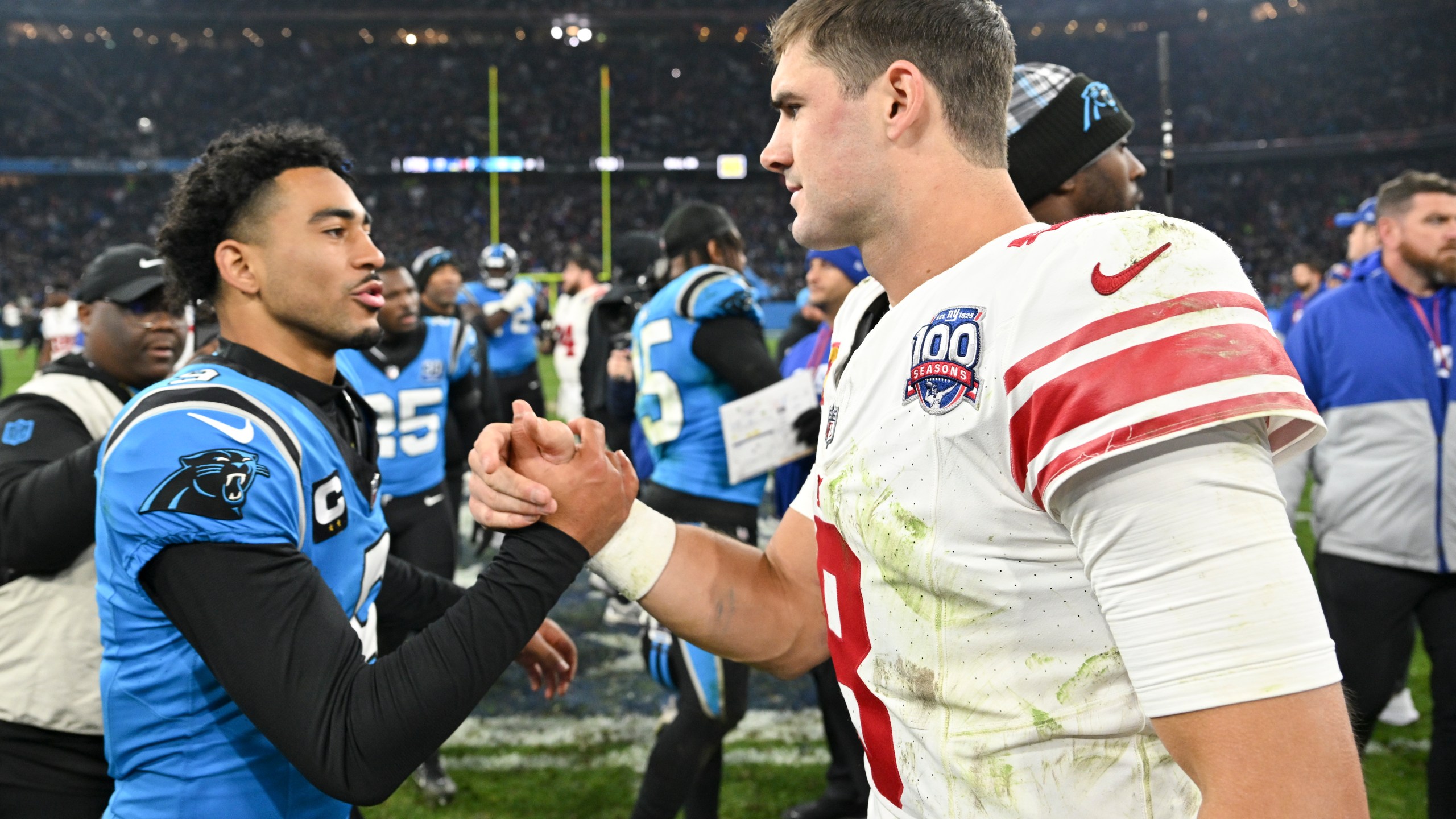 Carolina Panthers quarterback Bryce Young greets New York Giants quarterback Daniel Jones after their overtime win in an NFL football game, Sunday, Nov. 10, 2024, in Munich, Germany. (AP Photo/Lennart Preiss)